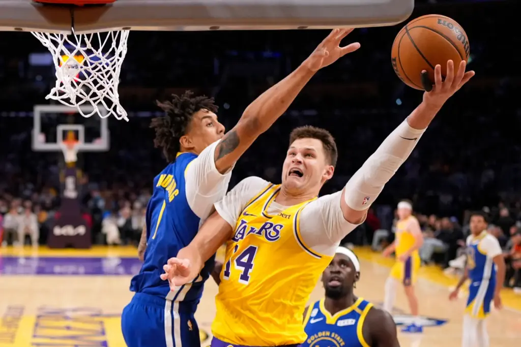 Lakers center Walker Kessler, right, shoots as Golden State Warriors...