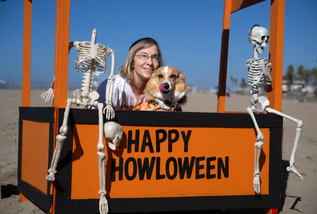 Karen Kettler poses in the Halloween kissing booth with Corey,...