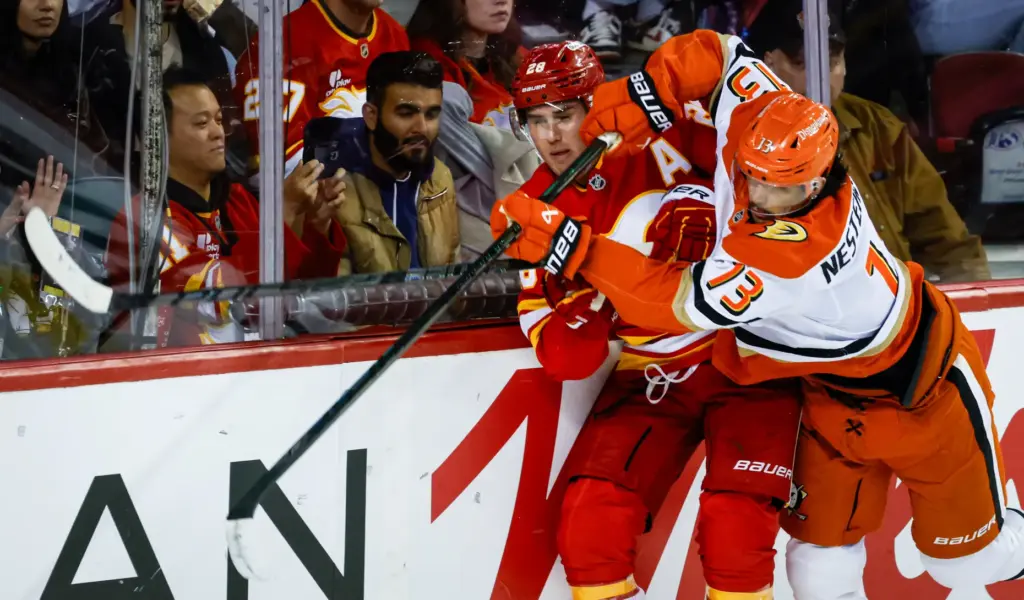 Ducks’ Nikita Nesterenko, right, checks Calgary Flames’ Zach Whitecloud during...