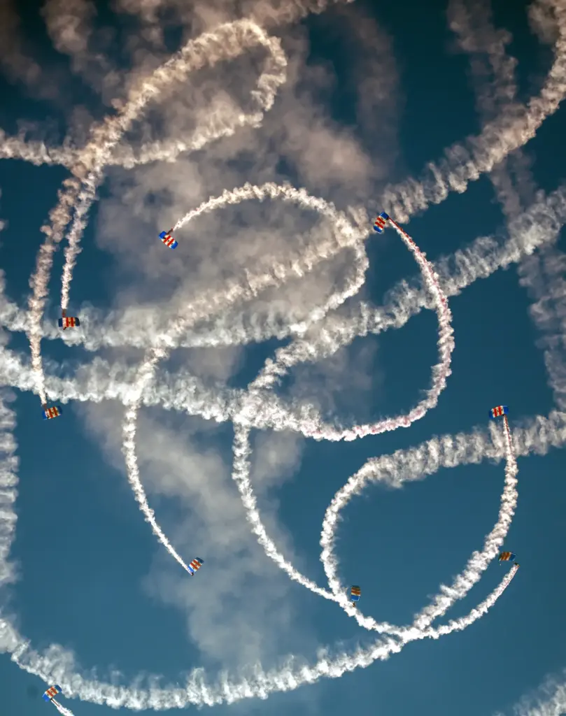 The Royal Air Force Falcons parachute team jump over the...