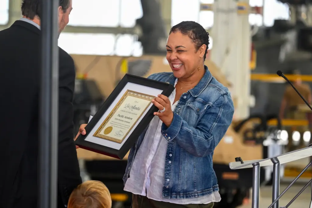 Tanya Doby, the mayor of Los Alamitos, delivers a certificate...