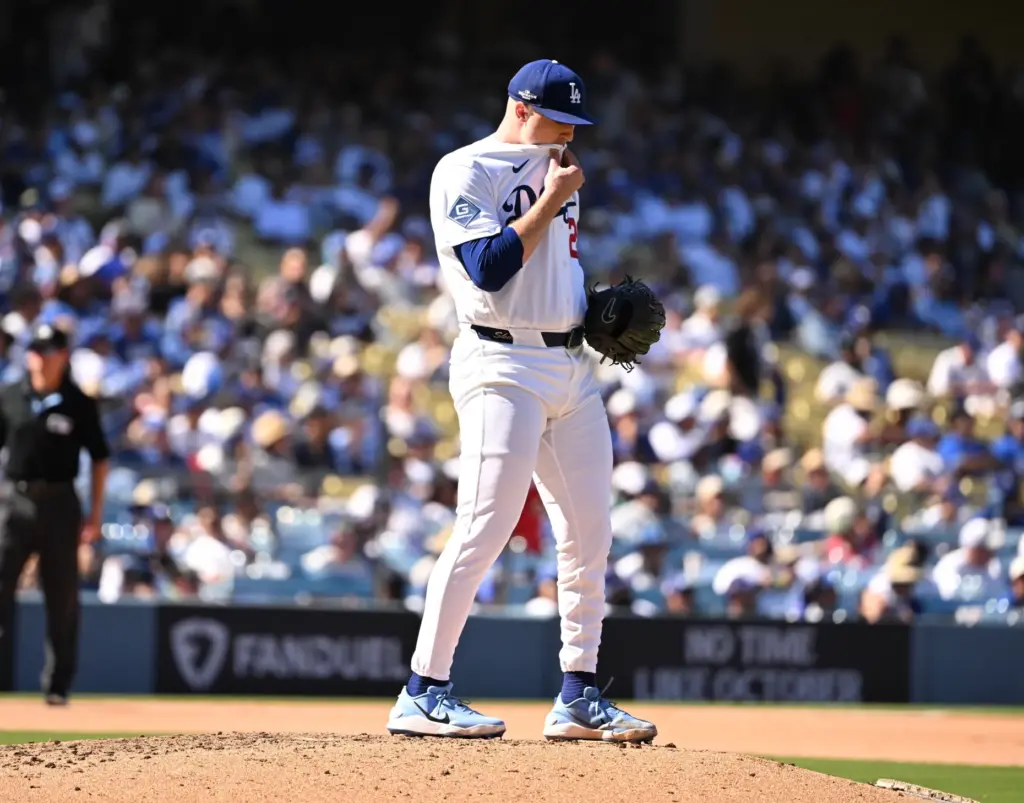 Dodgers starting pitcher Tarik Skubal wipes his face after giving...