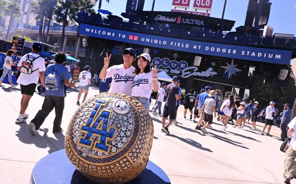 Fans pose for pictures with one of the oversized World...