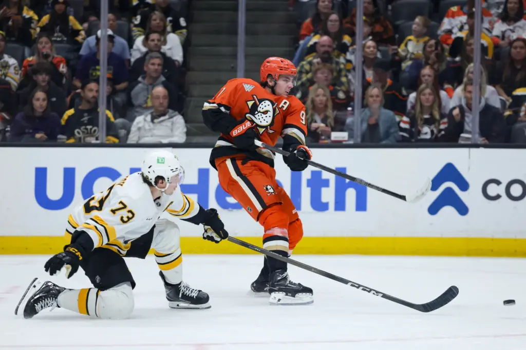 Ducks center Leo Carlsson, right, shoots the puck as Boston...