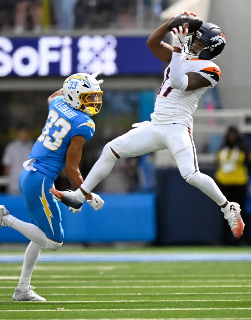 Denver wide receiver Jaylen Waddle hauls in a pass as...