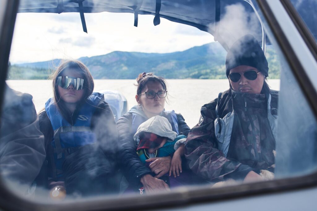 The Woods family travels by boat along the Yukon River...