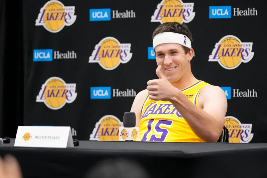 Lakers guard Austin Reaves gestures as he speaks to reporters...