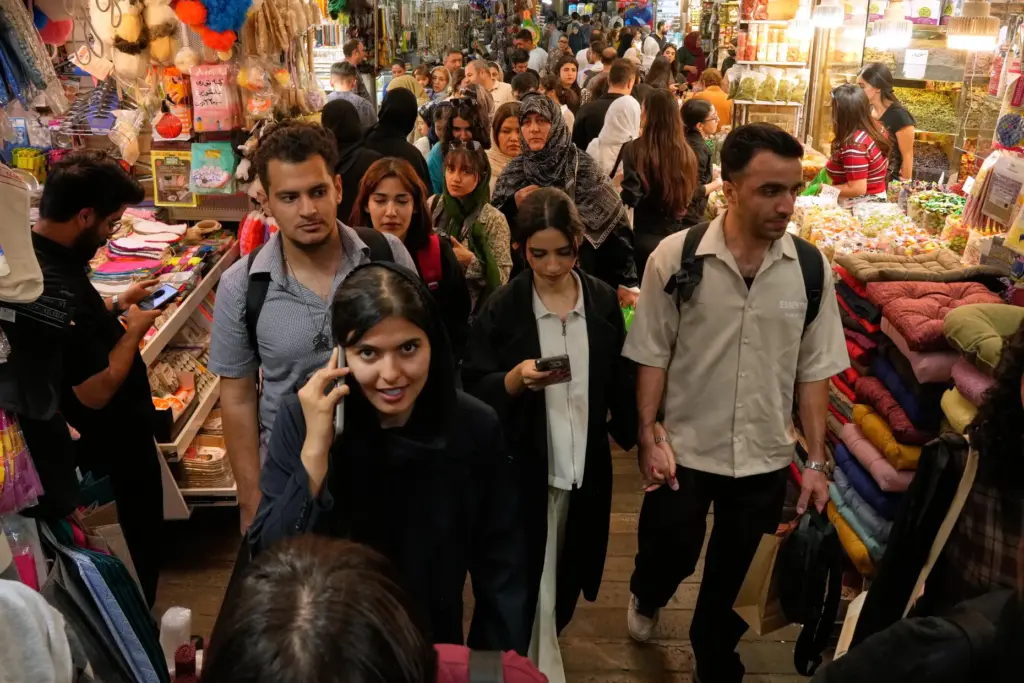 People walk at Tajrish traditional bazaar in Tehran, Iran, Thursday,...