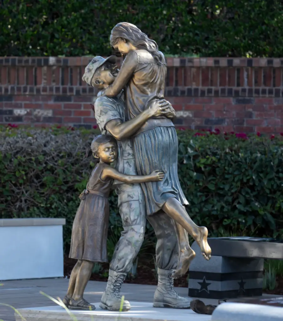 “Returning Home,” a bronze statue by artist Sutton Betti, pays...