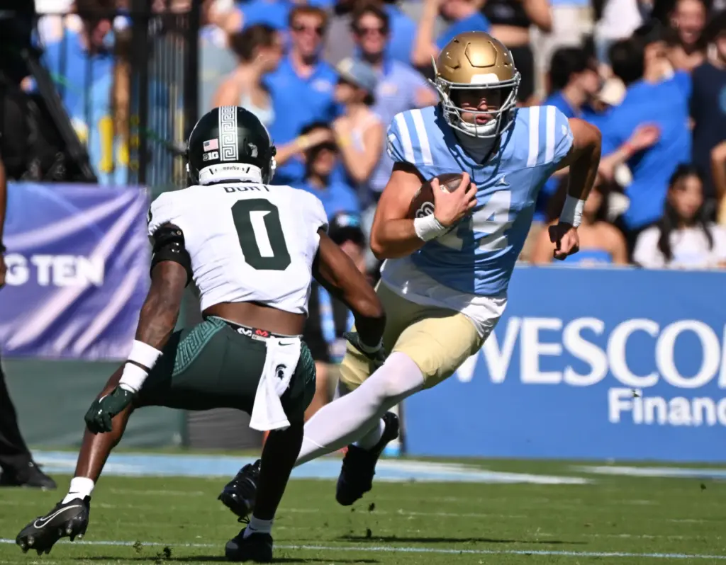 UCLA quarterback Ty Dieffenbach (14) scrambles for yardage against Michigan...