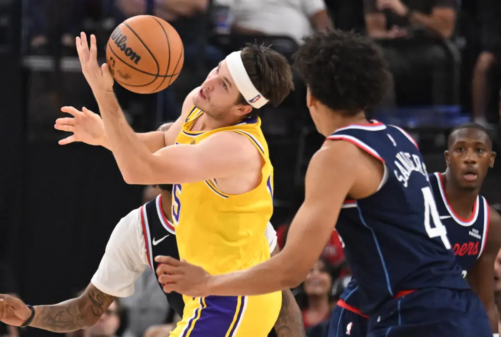 Lakers guard Austin Reaves, left, loses the ball in front...