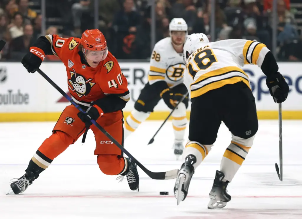 The Ducks’ Nikita Klepov, left, stick handles in front of...