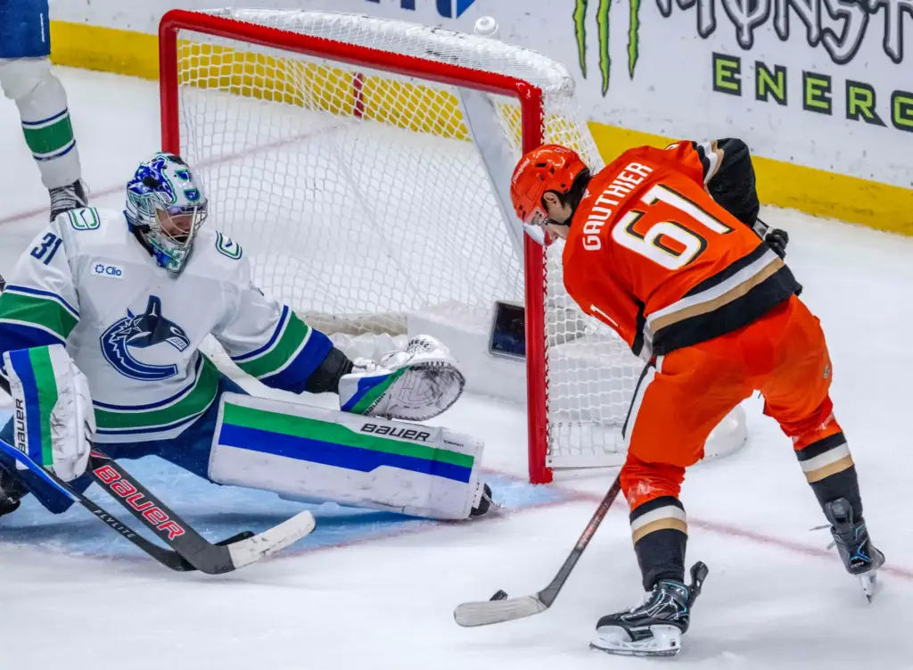 The Ducksâ Cutter Gauthier, right, shoots the puck as Vancouver...