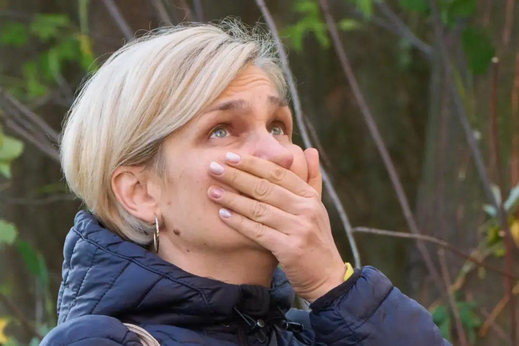 A woman reacts as she looks at their damaged home after Russia's night missile attack.