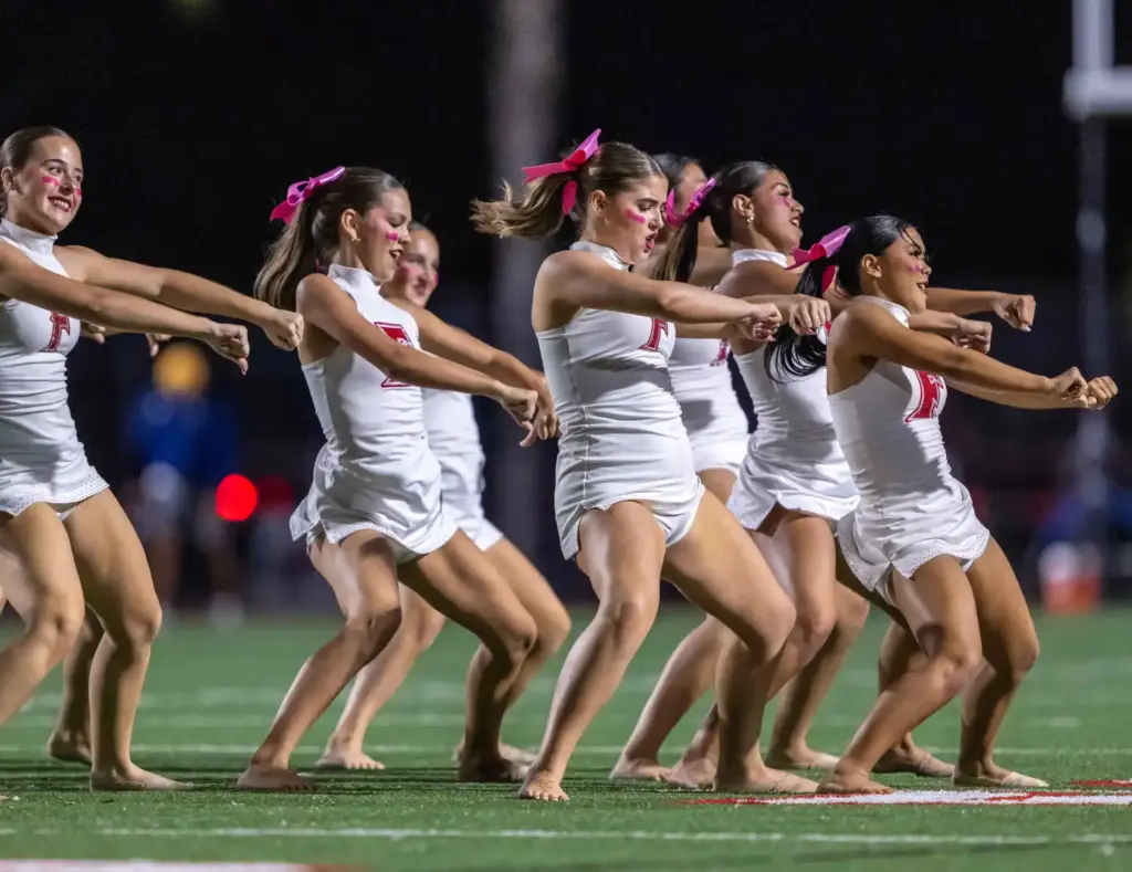 Fullerton dance team members perform on the field during halftime...