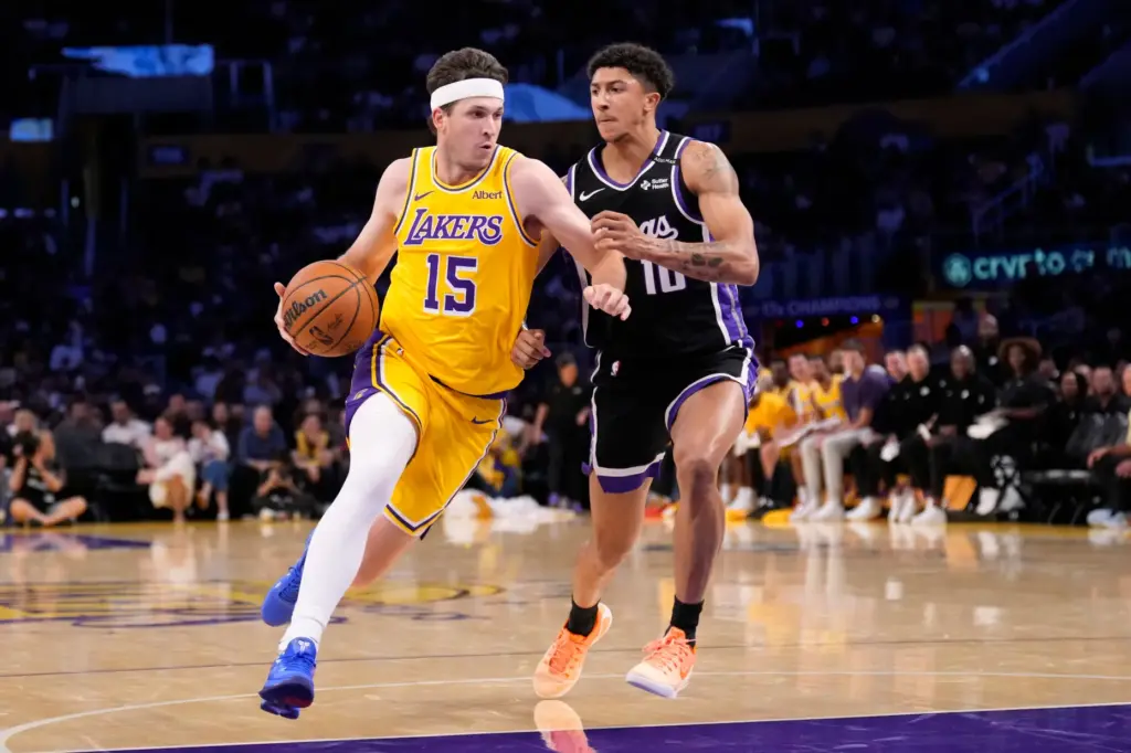 Lakers guard Austin Reaves, left, drives past Sacramento Kings guard...