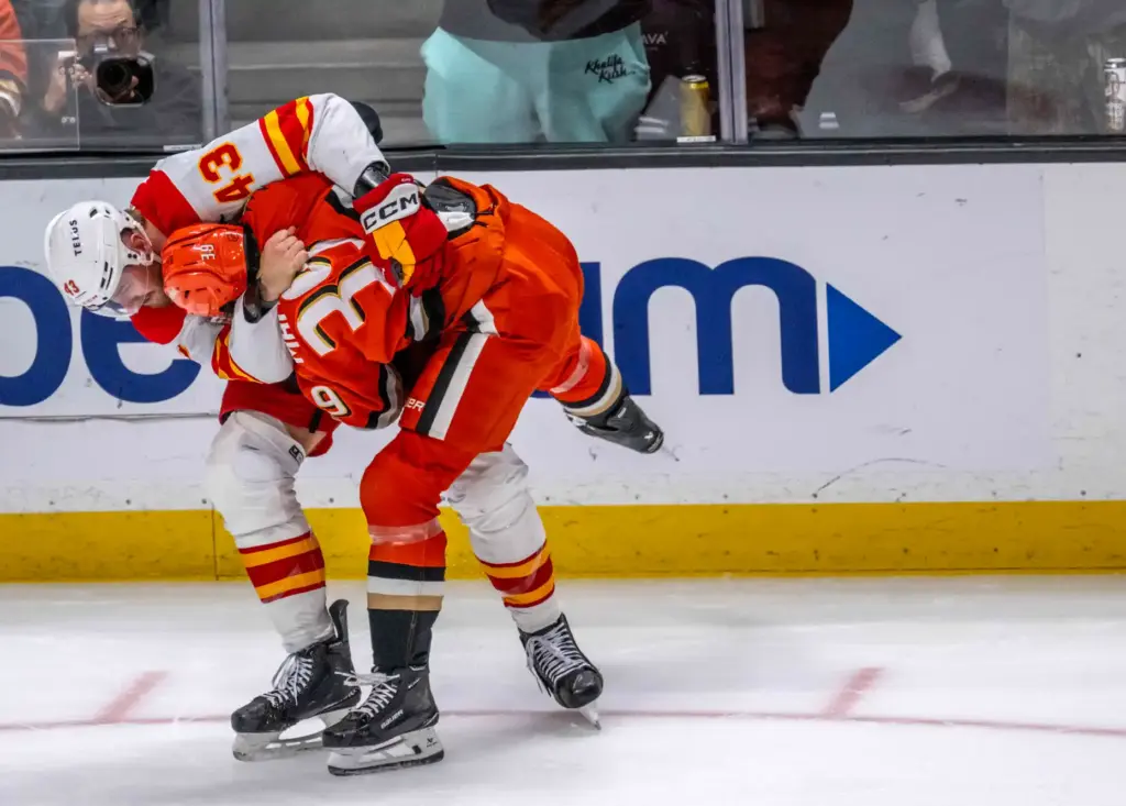 The Calgary Flamesâ Adam Klapka, left, and the Ducksâ Jeff...