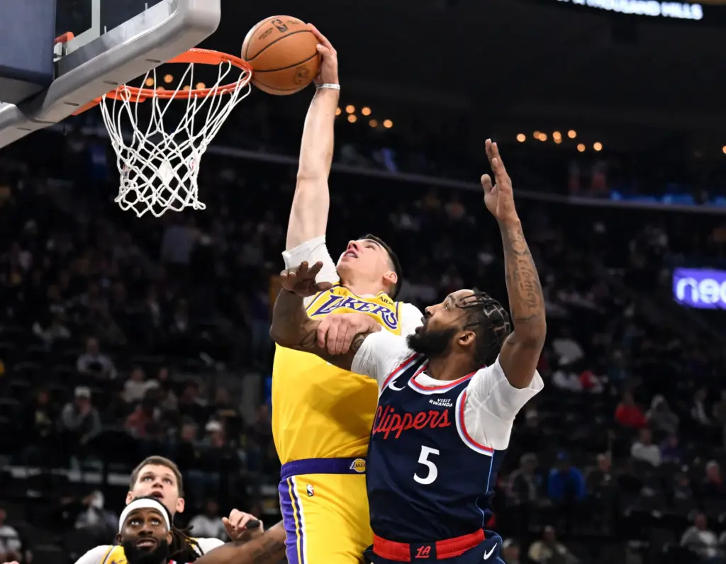Lakers forward Jake LaRavia drives to the basket as Clippers...