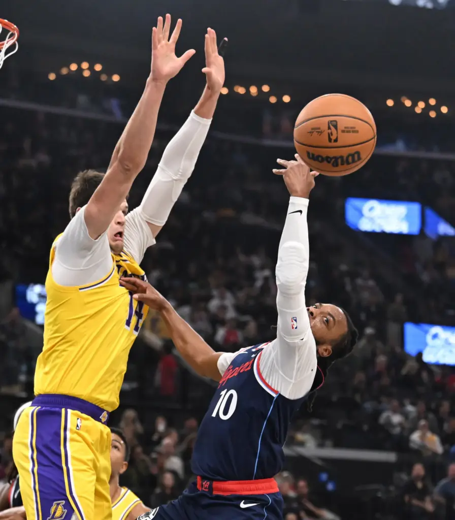Clippers point guard Darius Garland, right, loses the ball as...