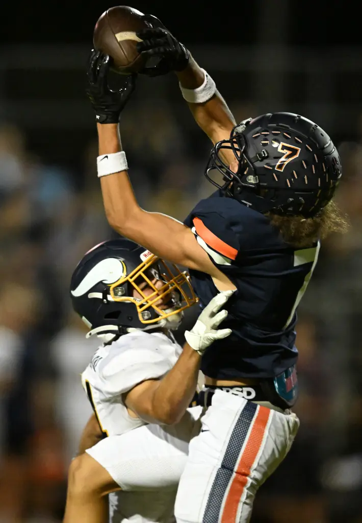 Mekaih Felix #7 of Cypress catches a pass over Lucas...