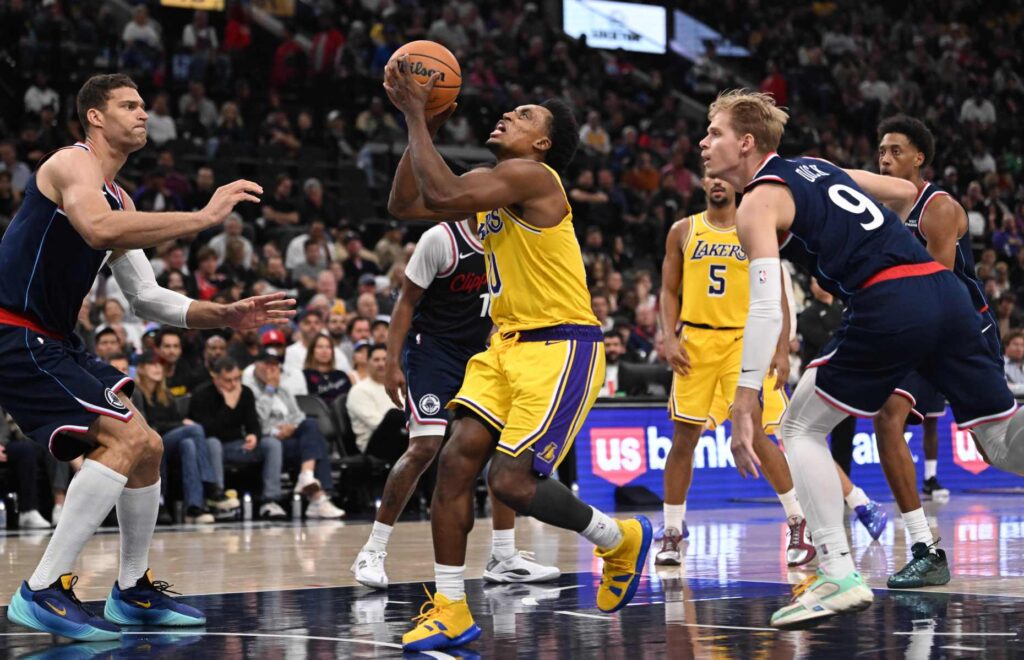 Lakers guard Collin Sexton drives to the basket as Clippers...