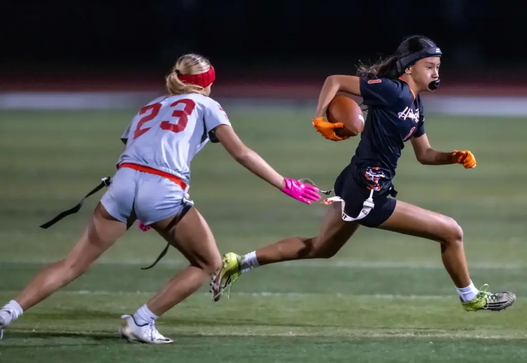 Huntington Beach running back Kyla Uno (1), right, carries the...