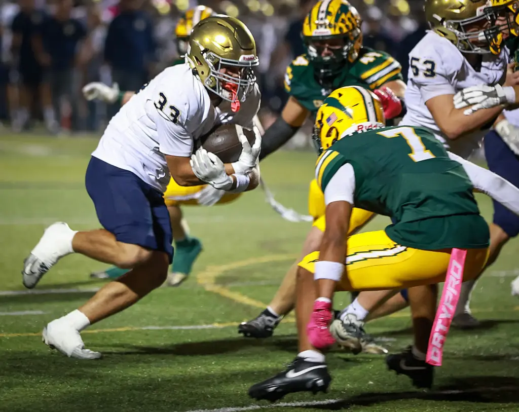 San Juan Hillsâ Jack Smith, left, runs into Edison defenders...