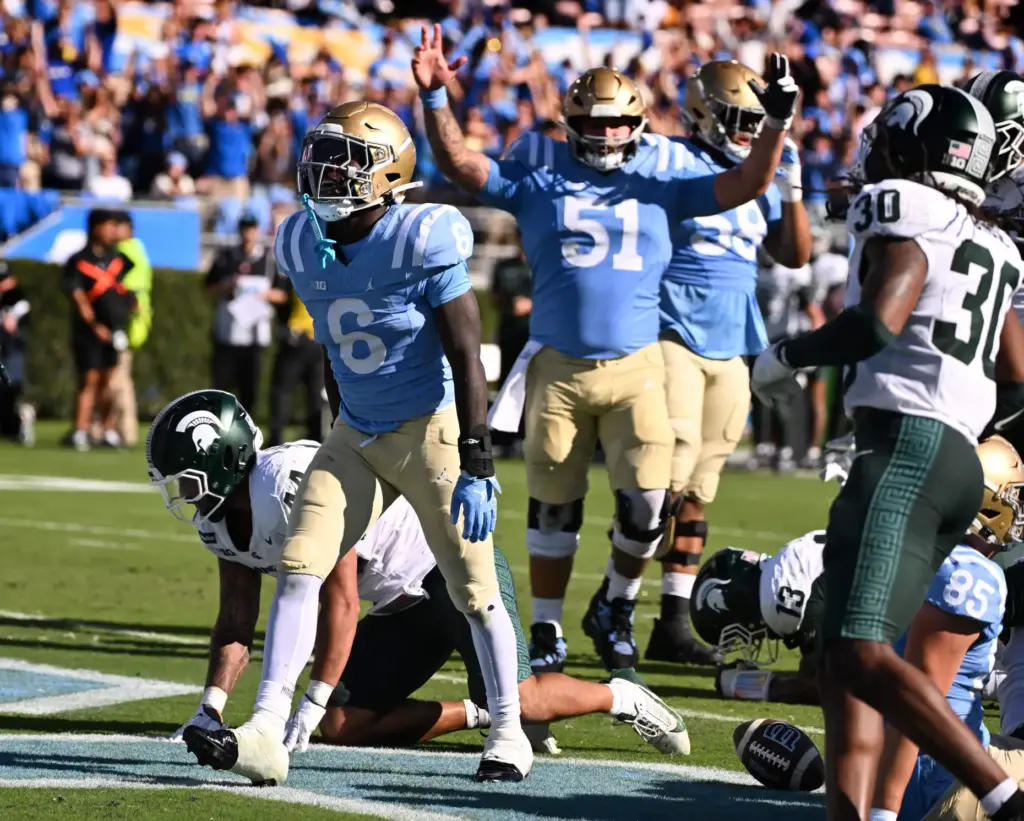 UCLA running back Anthony Woods (6) celebrates after scoring on...