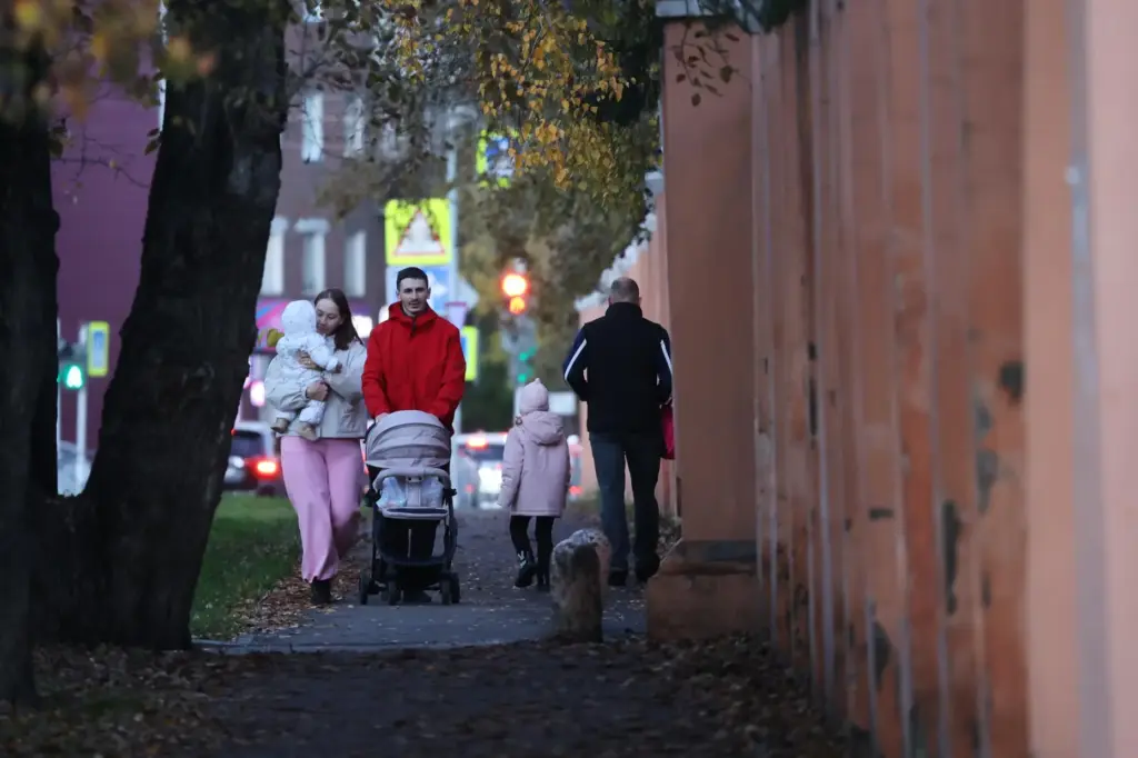 People walk past the fence of the Irkutsk Anti-Plague Research Institute of Siberia.