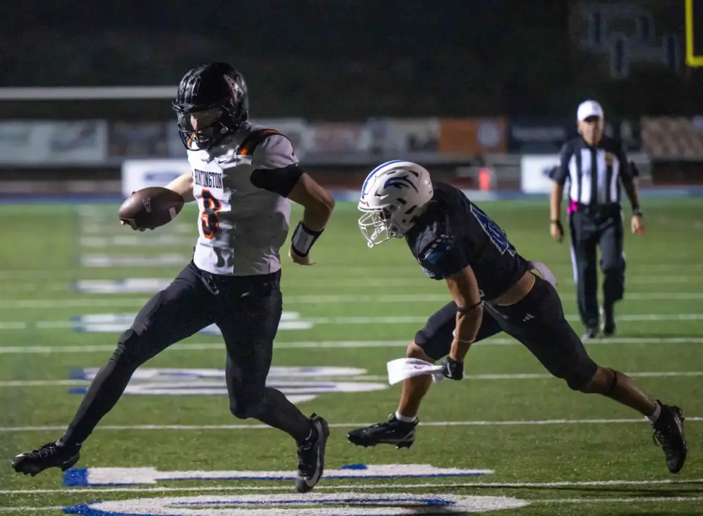 Huntington Beach quarterback Brady Edmunds (9) carries the ball for...