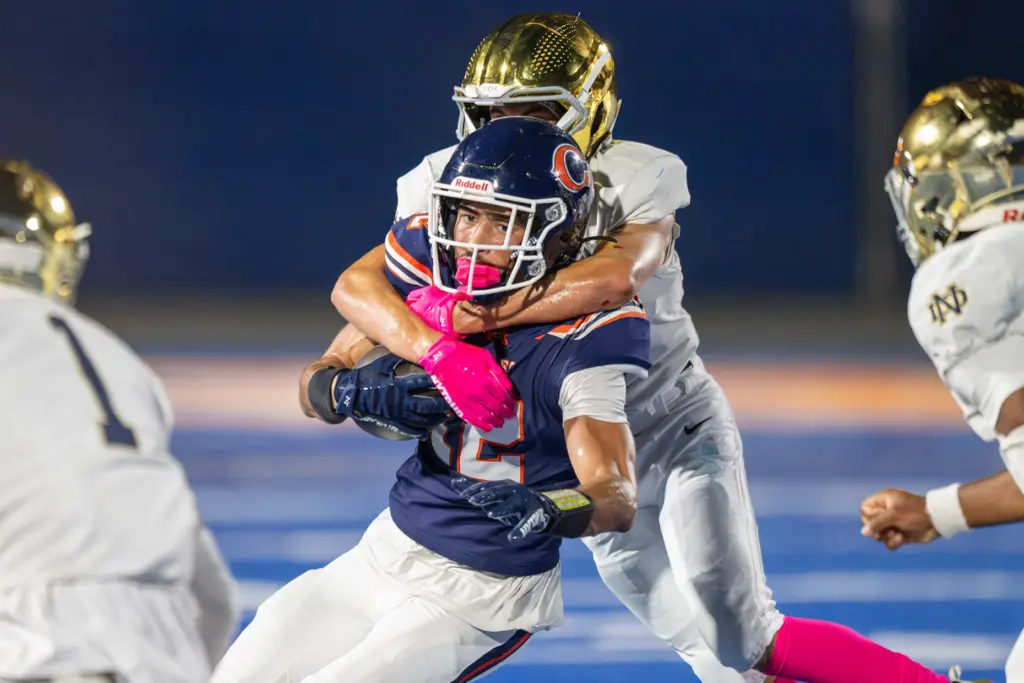 Chaminade High Schoolâs Andrew Cordero (12) is wrapped up by...