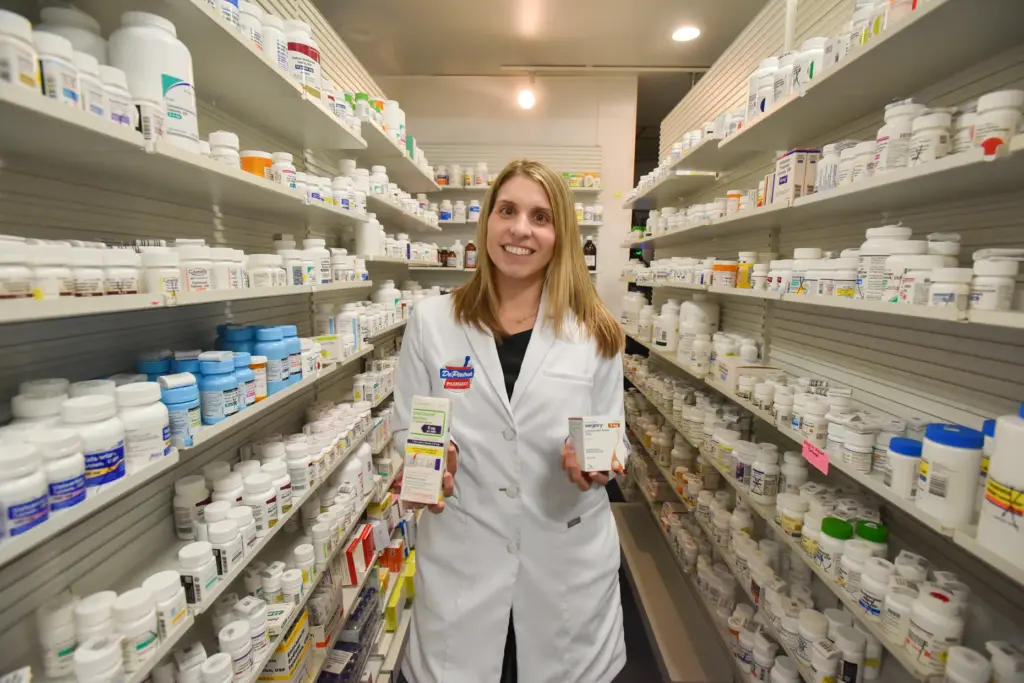 Pharmacist Sarah Ferry holds up packages of the GLP-1 medication...