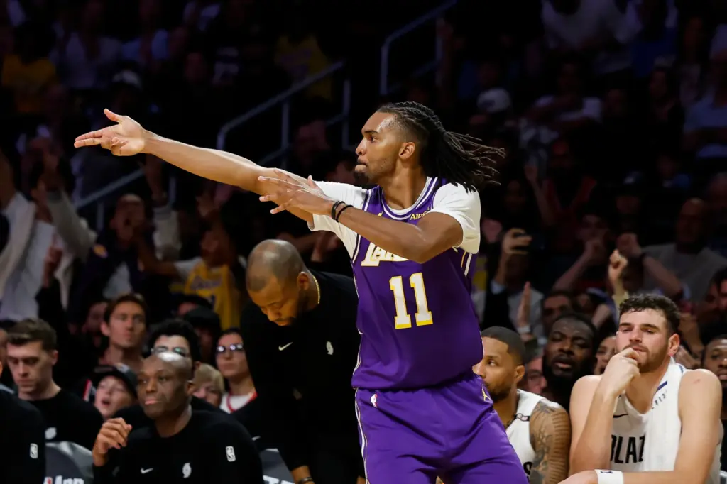 Lakers forward Ziaire Williams gestures after making a 3-point shot...