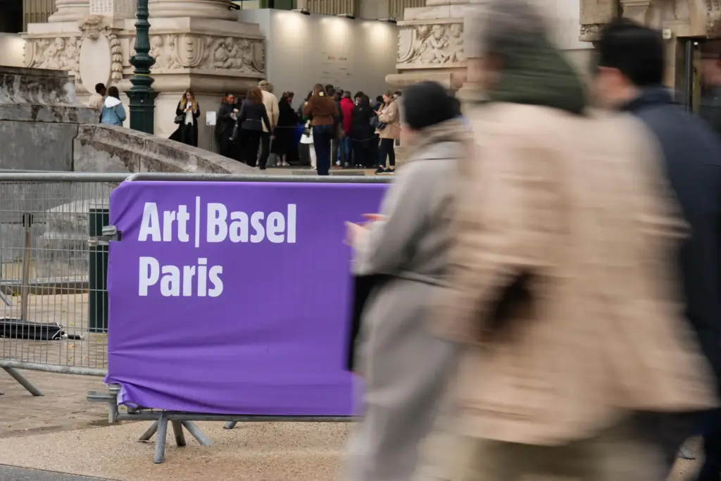 People walk past the Paris' Grand Palais hosting Art Basel art fair