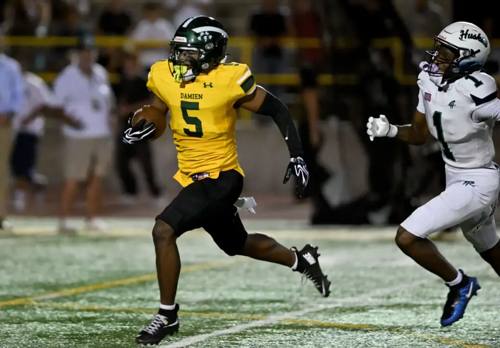 Damien Spartans Dupri Stevenson-Dorsey (5) runs the ball in for...