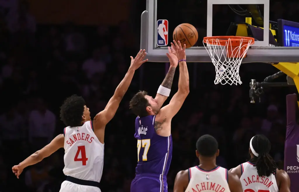 Lakers star Luka Doncic (77) gets to the basket for...