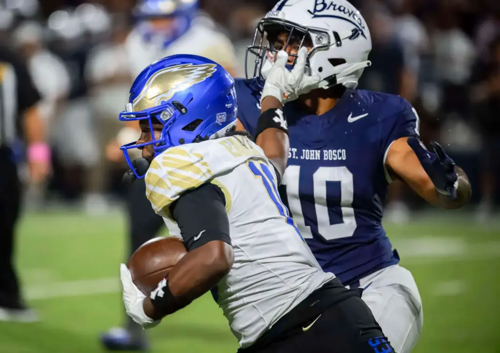 Santa Margarita wide receiver Kiyan Callis, left, pushes St. John...