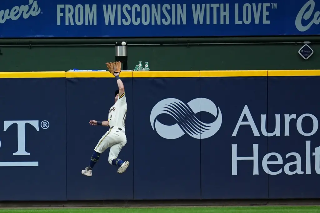 Milwaukee Brewers right fielder Sal Frelick leaps to catch a...