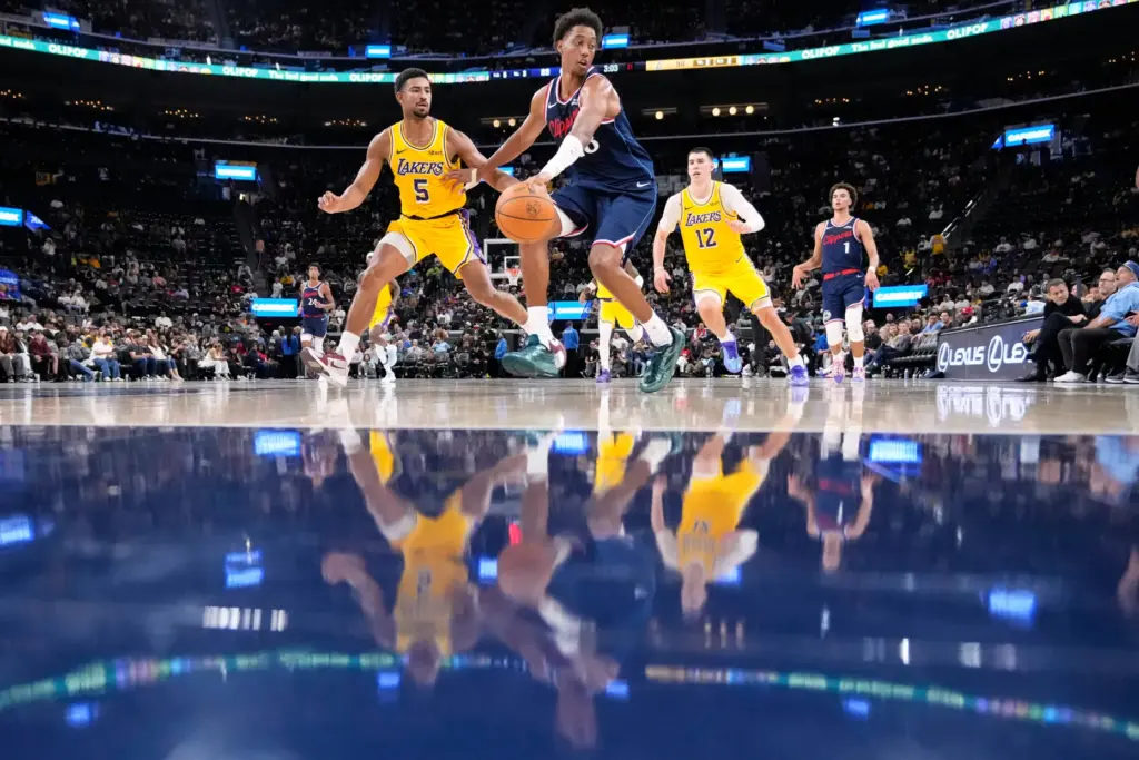Clippers forward Baba Miller, second from left, dribbles the ball...