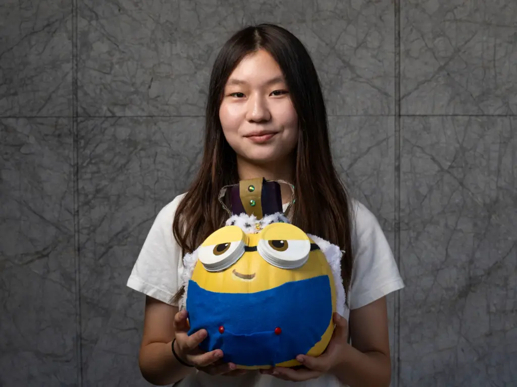Erin Yoo holds her pumpkin titled âKing Bob the Minionâ...