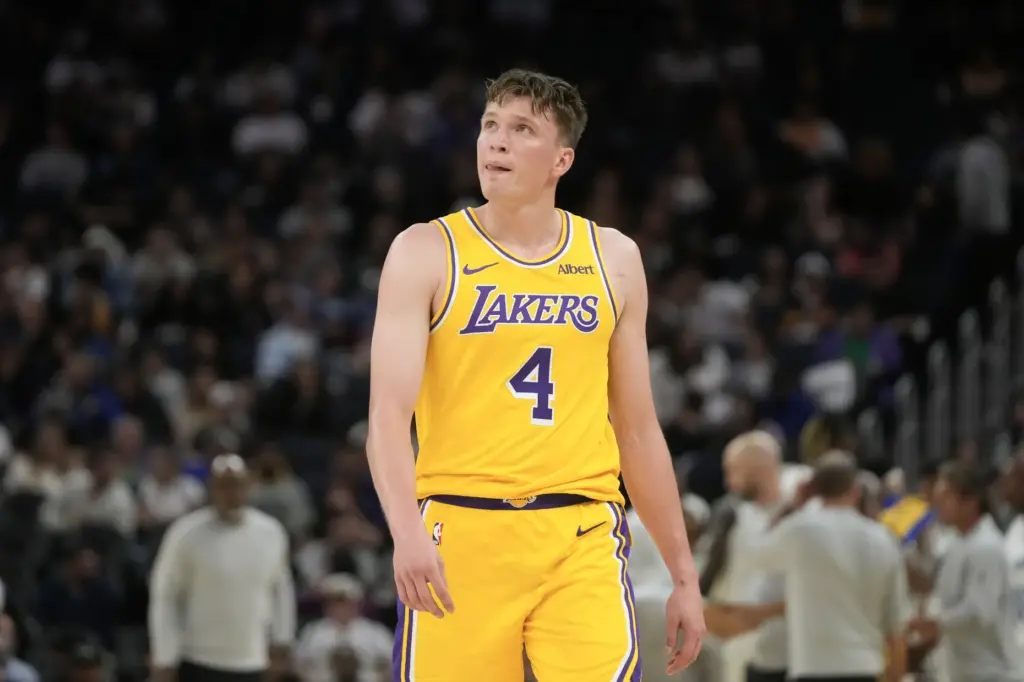 Lakers forward Dalton Knecht walks toward the bench during the...