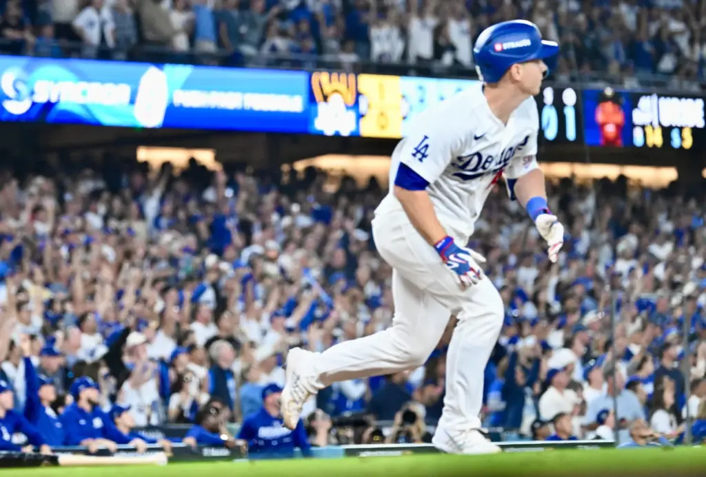 The Dodgers’ Will Smith begins to run as he watches...