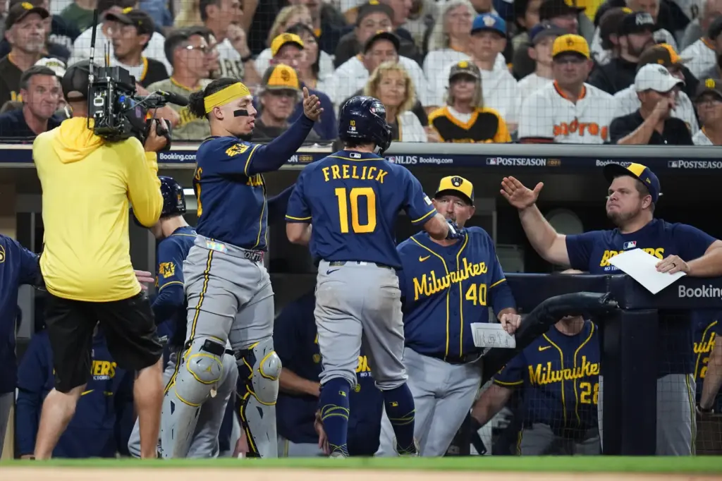 The Milwaukee Brewers’ Sal Frelick (10) is greeted by teammates...