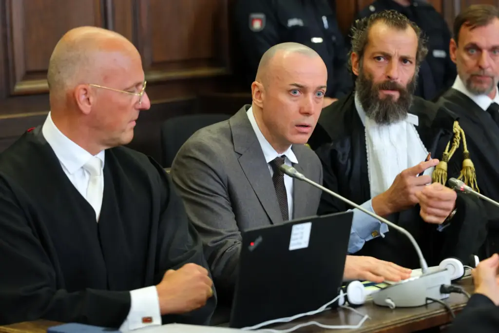 The defendant, Serhii Kuznietsov, sits between his attorneys during trial.