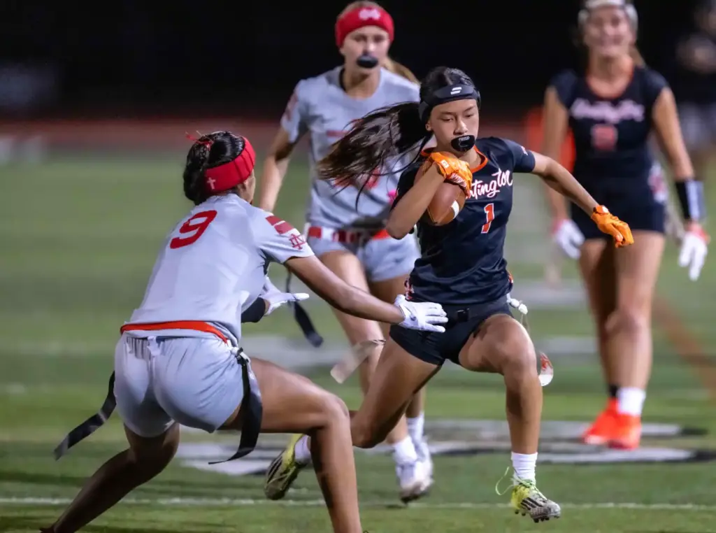 Huntington Beach running back Kyla Uno (1), right, carries the...
