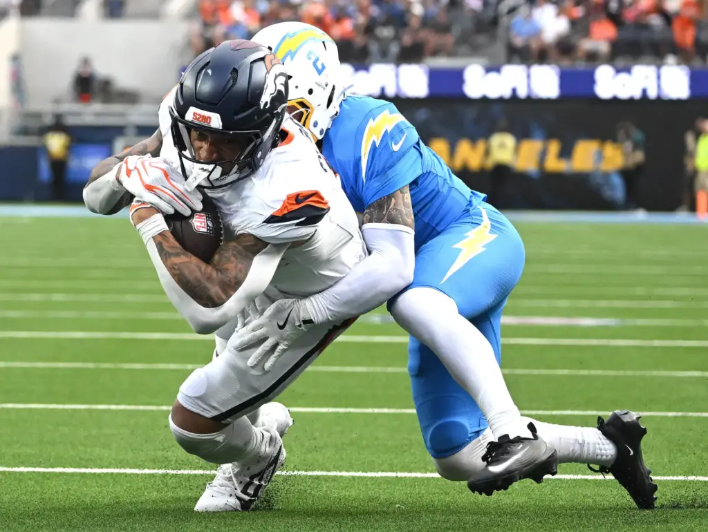 Denver wide receiver Evan Engram (1) is tackled short of...