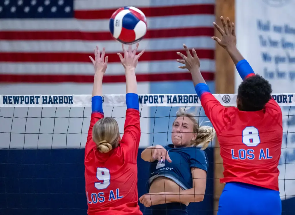 Newport Harbor outside hitter Ella Olson (2) hits the ball...