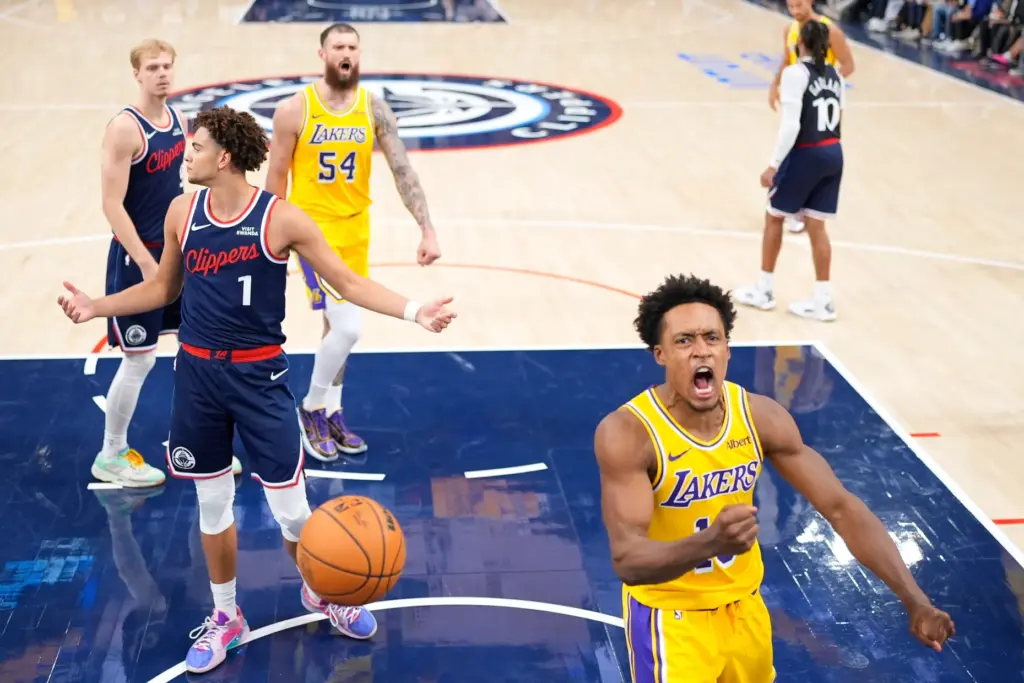 Lakers guard Collin Sexton, right, celebrates after scoring as Clippers...