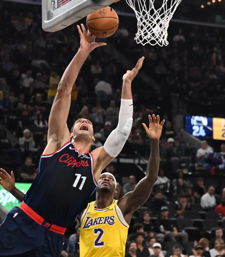 Clippers center Brook Lopez gets to the basket for a...