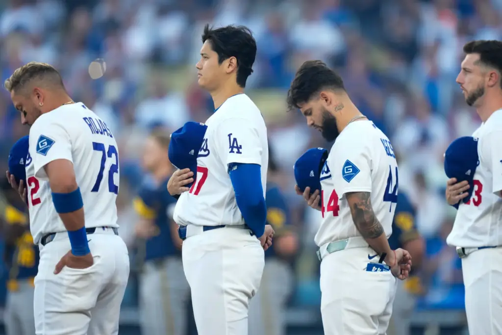 Dodgers star Shohei Ohtani (17) stands with teammates Miguel Rojas...